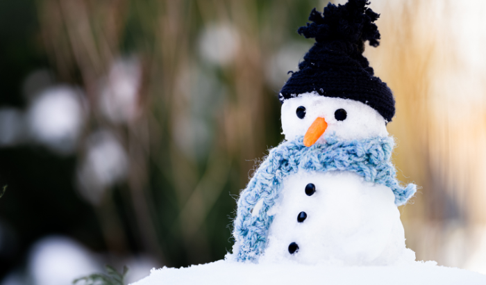 A snowman wearing a hat and a scarf in Cornwall in December